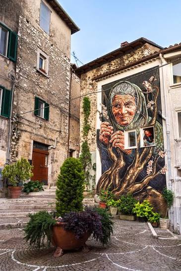 Murale con volto di anziana su una facciata del borgo antico di Fiuggi
