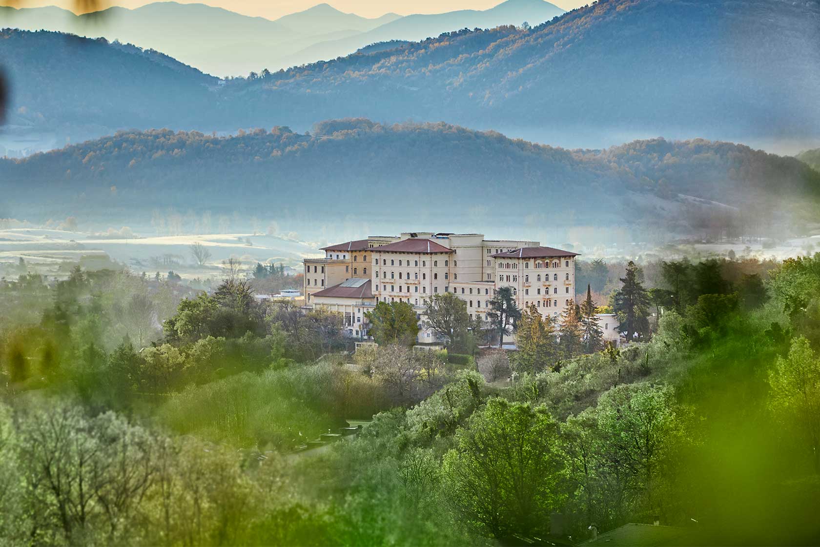 Il palazzo termale di Fiuggi immerso nel verde, con le montagne della valle sullo sfondo